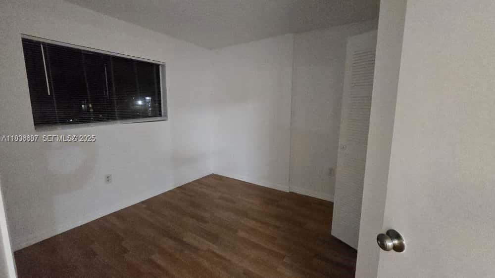 301 Palm Way, Unit 205 Pembroke Pines, FL 33025 - Photo 13 of 23 a view of a livingroom with wooden floor and a cabinet