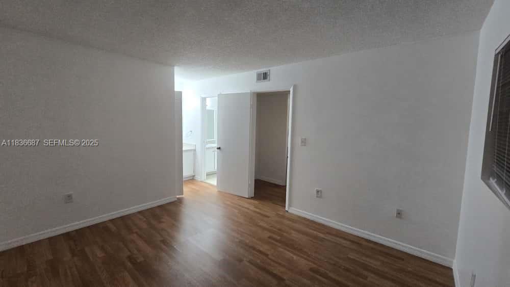 301 Palm Way, Unit 205 Pembroke Pines, FL 33025 - Photo 14 of 23 a view of an empty room with wooden floor