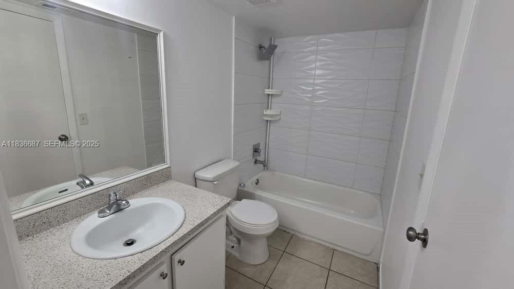 301 Palm Way, Unit 205 Pembroke Pines, FL 33025 - Photo 19 of 23 a bathroom with a granite countertop sink a toilet and shower