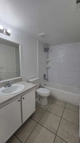 a bathroom with a double vanity sink toilet and a bathtub