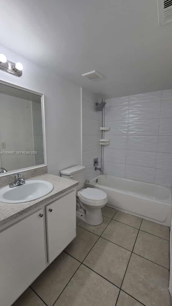 301 Palm Way, Unit 205 Pembroke Pines, FL 33025 - Photo 21 of 23 a bathroom with a double vanity sink toilet and a bathtub