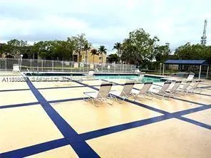 a view of a swimming pool with a lawn chairs