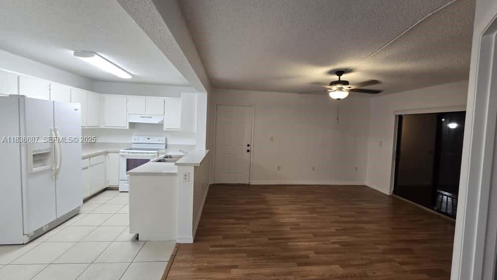 301 Palm Way, Unit 205 Pembroke Pines, FL 33025 - Photo 3 of 23 a kitchen with a sink stainless steel appliances cabinets and a counter top space