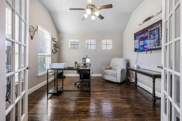 a living room with furniture and a wooden floor