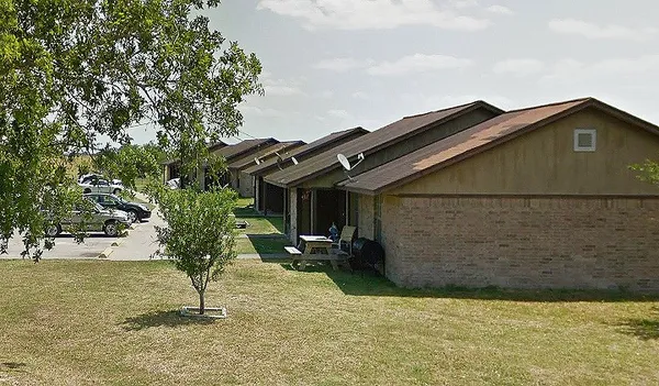a backyard of a house with table and chairs