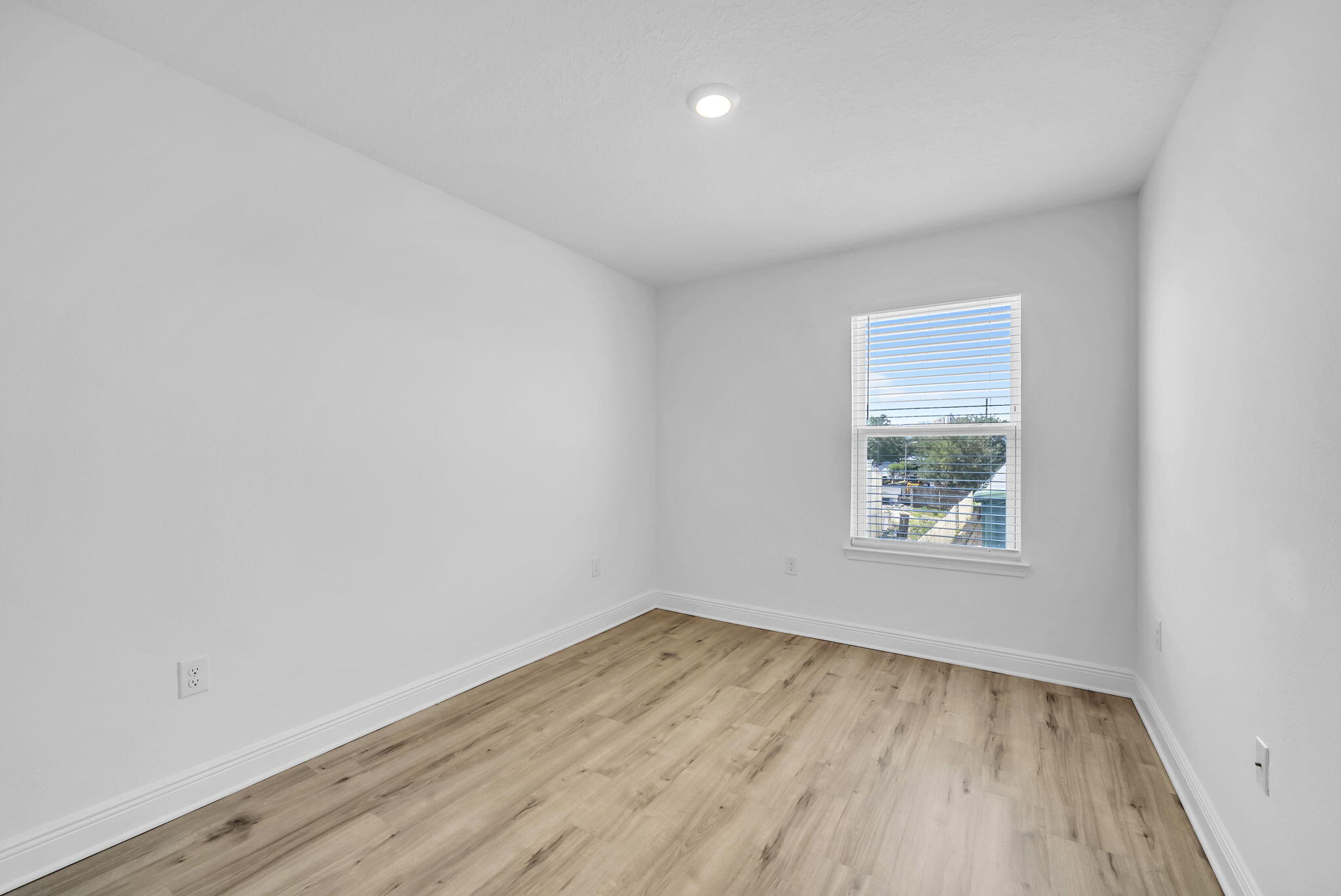 22 Redbird Loop Destin, FL 32541 - Photo 31 of 40 an empty room with wooden floor and windows