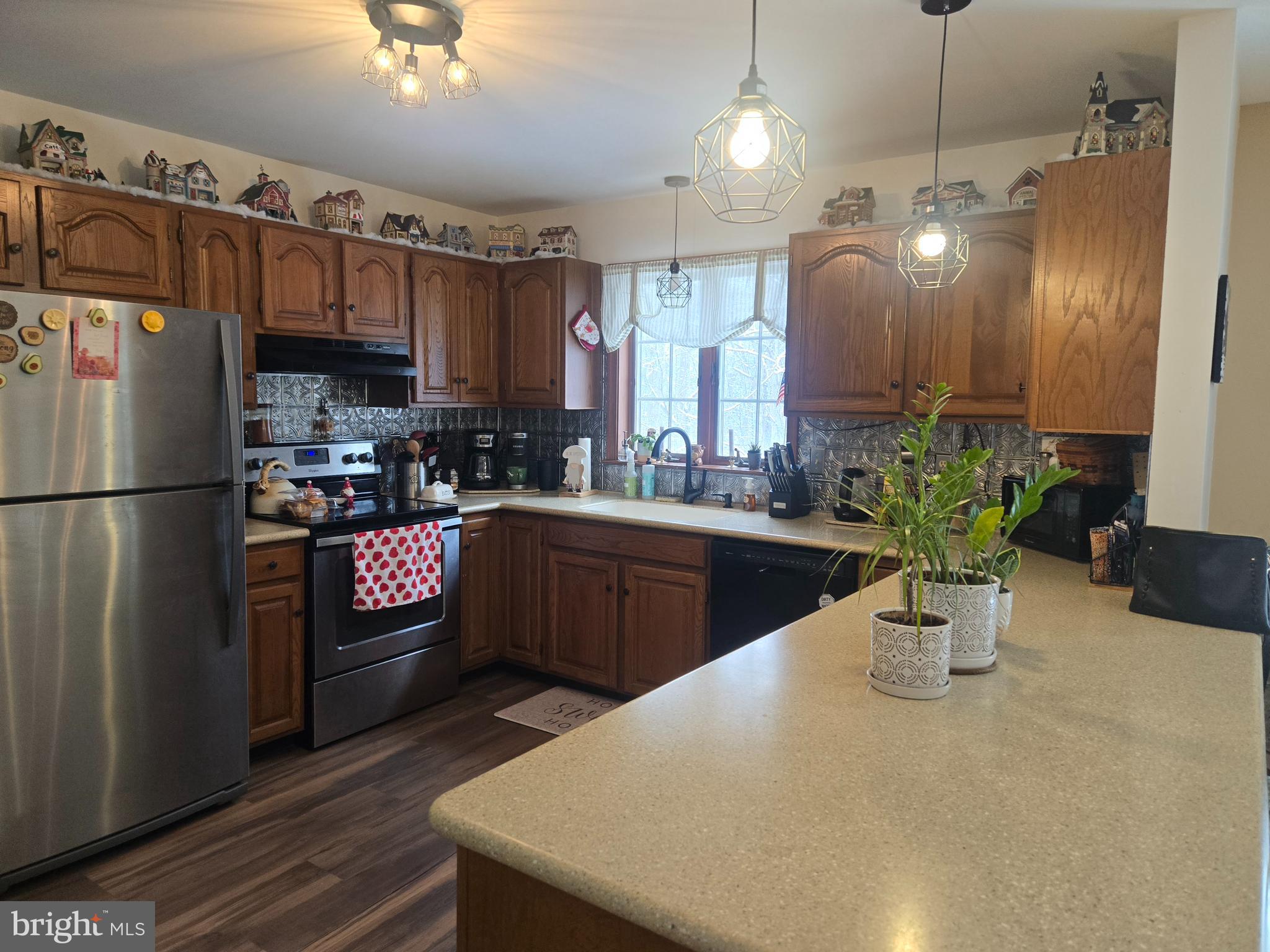 3 White Oak Road Fleetwood, PA 19522 - Photo 12 of 48 a kitchen with stainless steel appliances kitchen island granite countertop a refrigerator a sink dishwasher a dining table and chairs with wooden floor