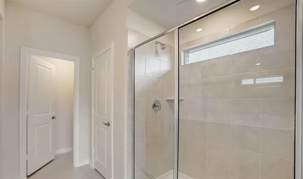 a bathroom with a glass shower door