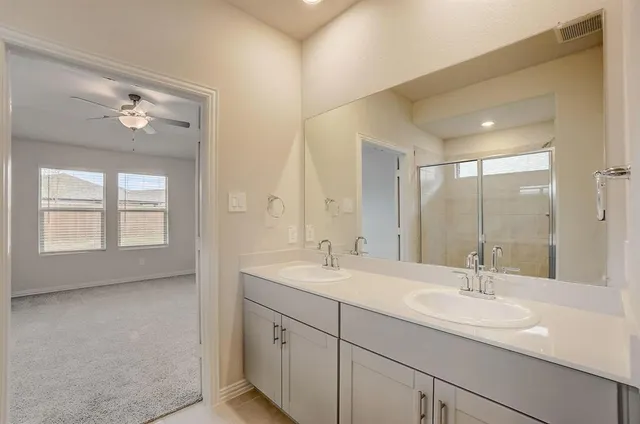 a bathroom with a sink double vanity and a mirror