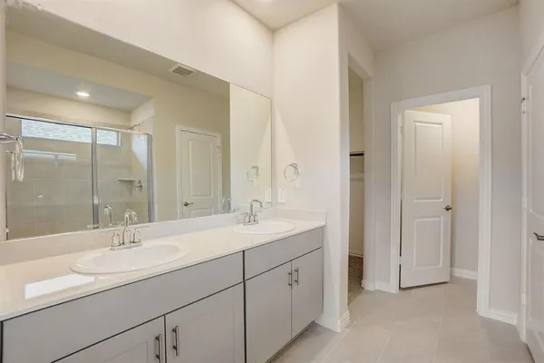 a bathroom with a sink double vanity and a mirror