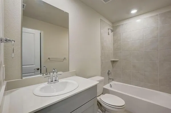a bathroom with a sink a toilet and bathtub
