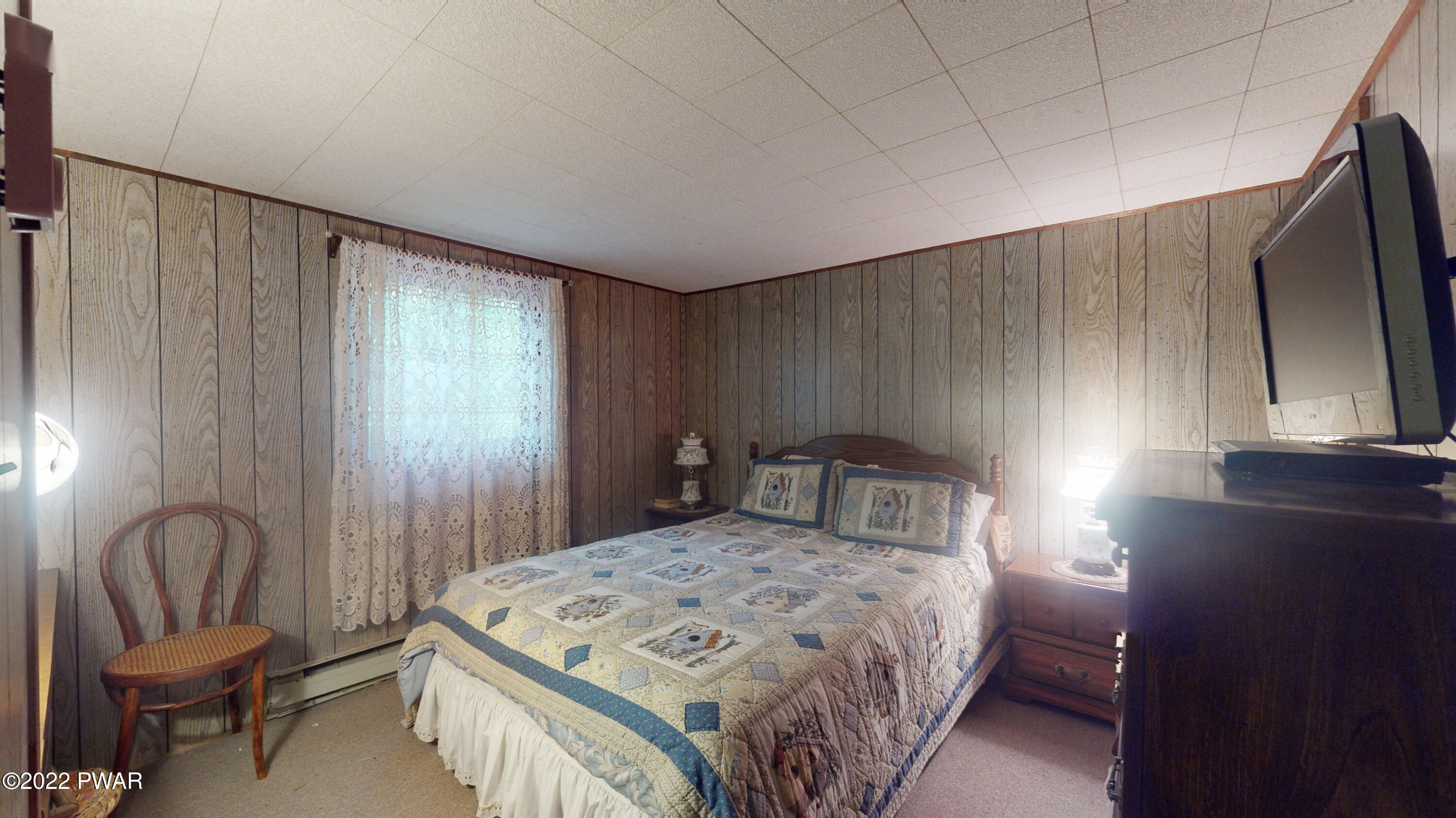 137 Stamford Road Dingmans Ferry, PA 18328 - Photo 8 of 31 a bedroom with a bed and chair