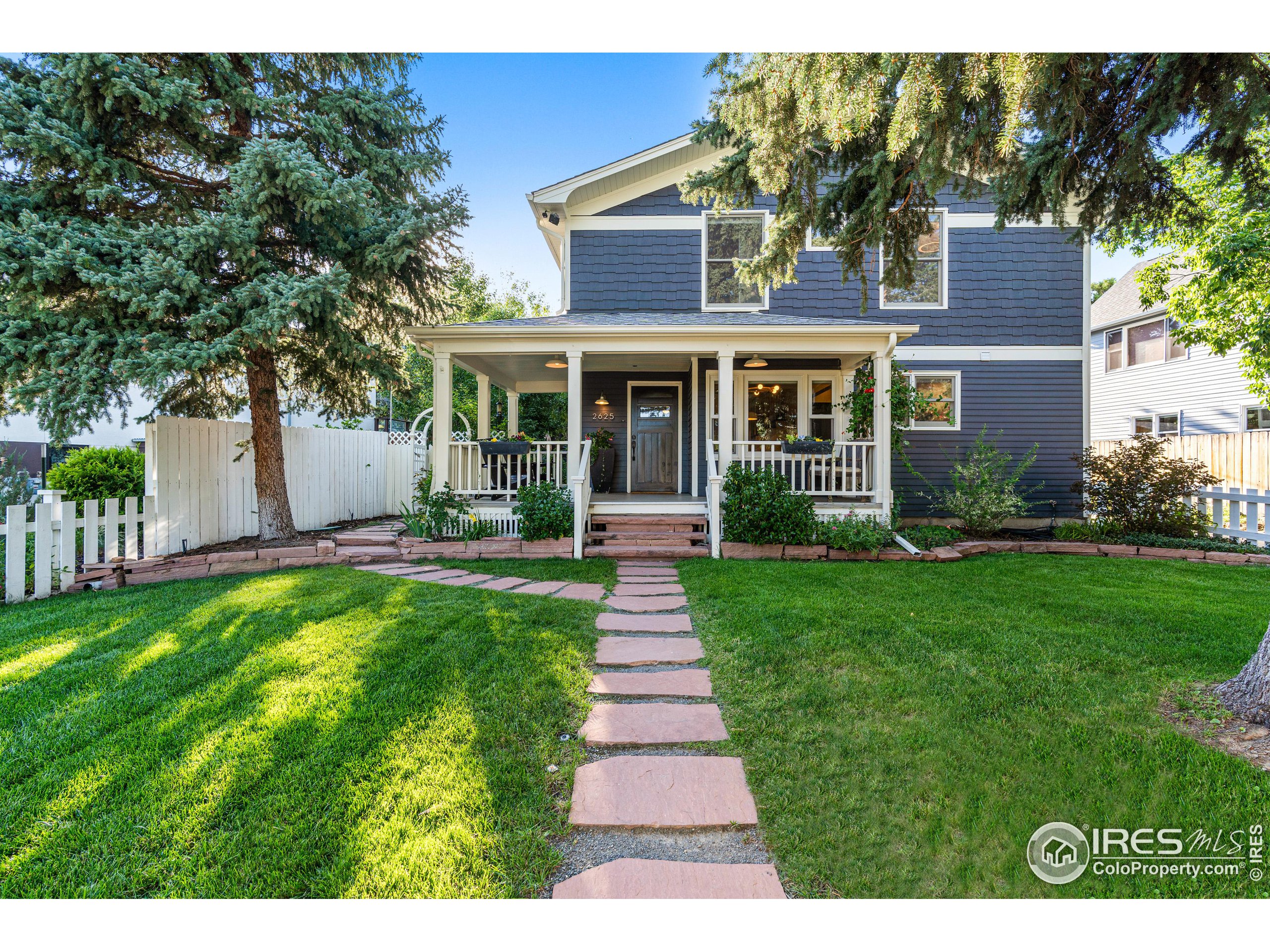 2625 6th Street Boulder, CO 80304 - Photo 1 of 33 a front view of a house with a garden and yard