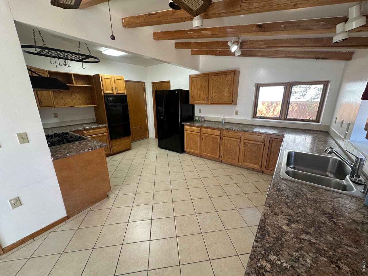 268 Fifth Street Firestone, CO 80520 - Photo 7 of 25 a large kitchen with a stove a refrigerator and a sink