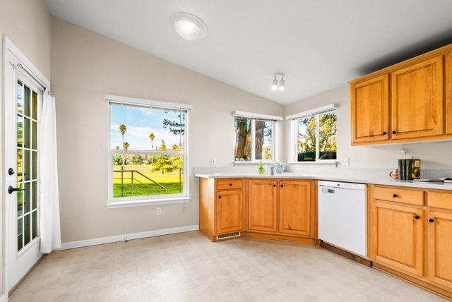 a kitchen with sink and cabinets