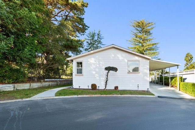 a view of a house with a yard and garage