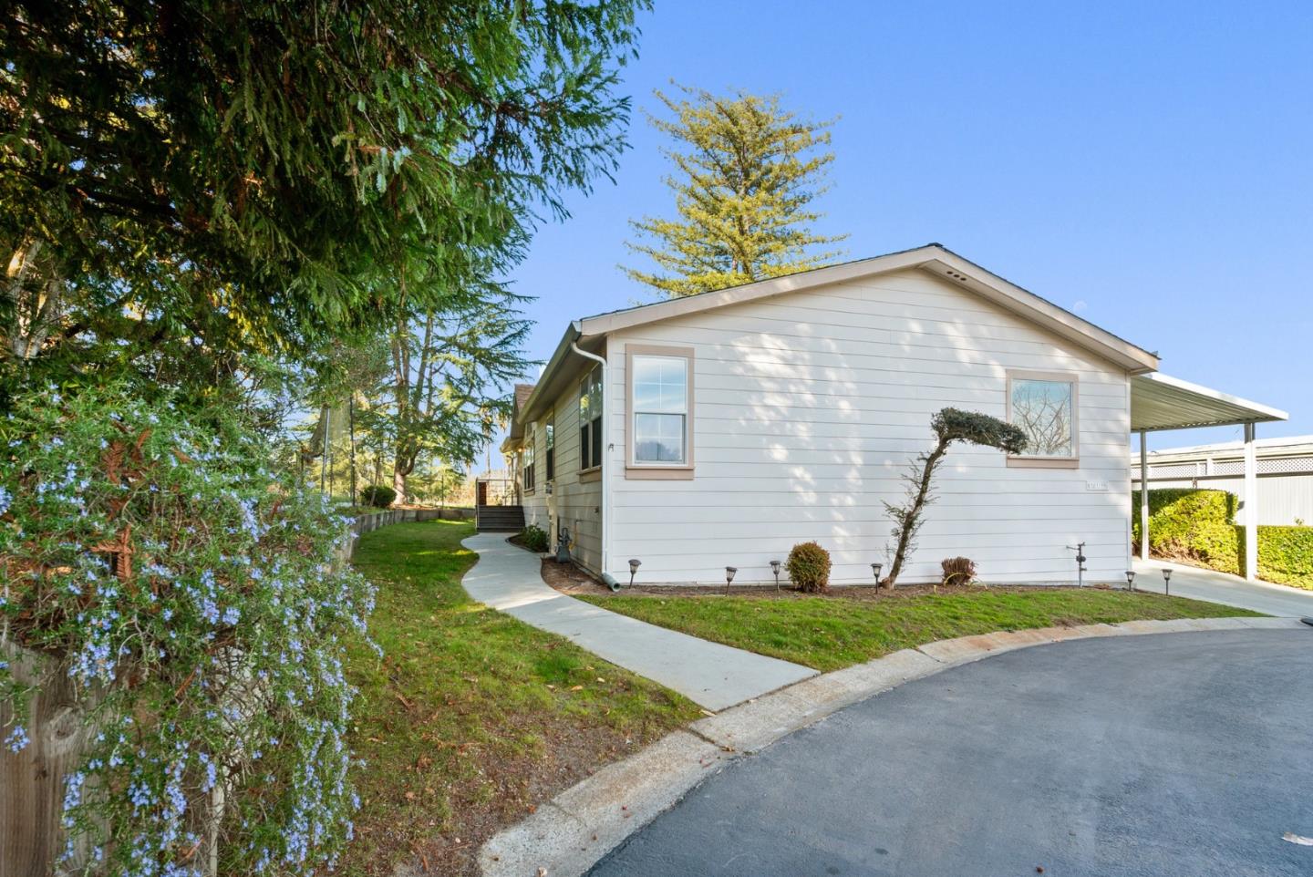 225 Mt Hermon Road, Unit 199 Scotts Valley, CA 95066 - Photo 3 of 44 a front view of a house with a yard and garage