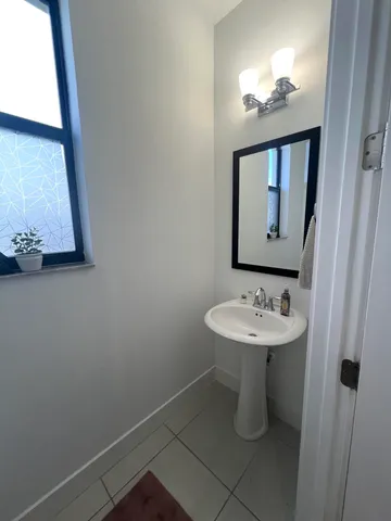 a bathroom with a sink a mirror and vanity