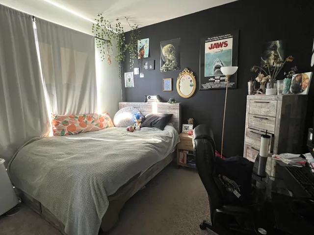 a bedroom with bed and a window