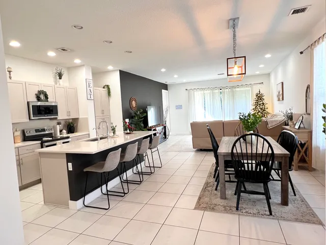 a large kitchen with a table and chairs