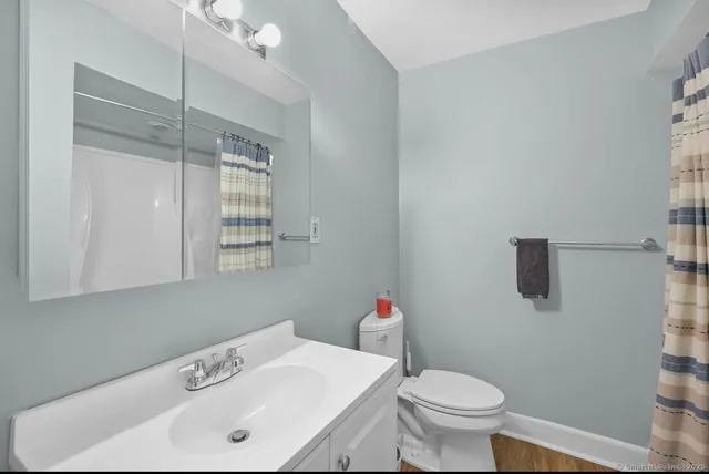 a bathroom with a sink toilet and shower