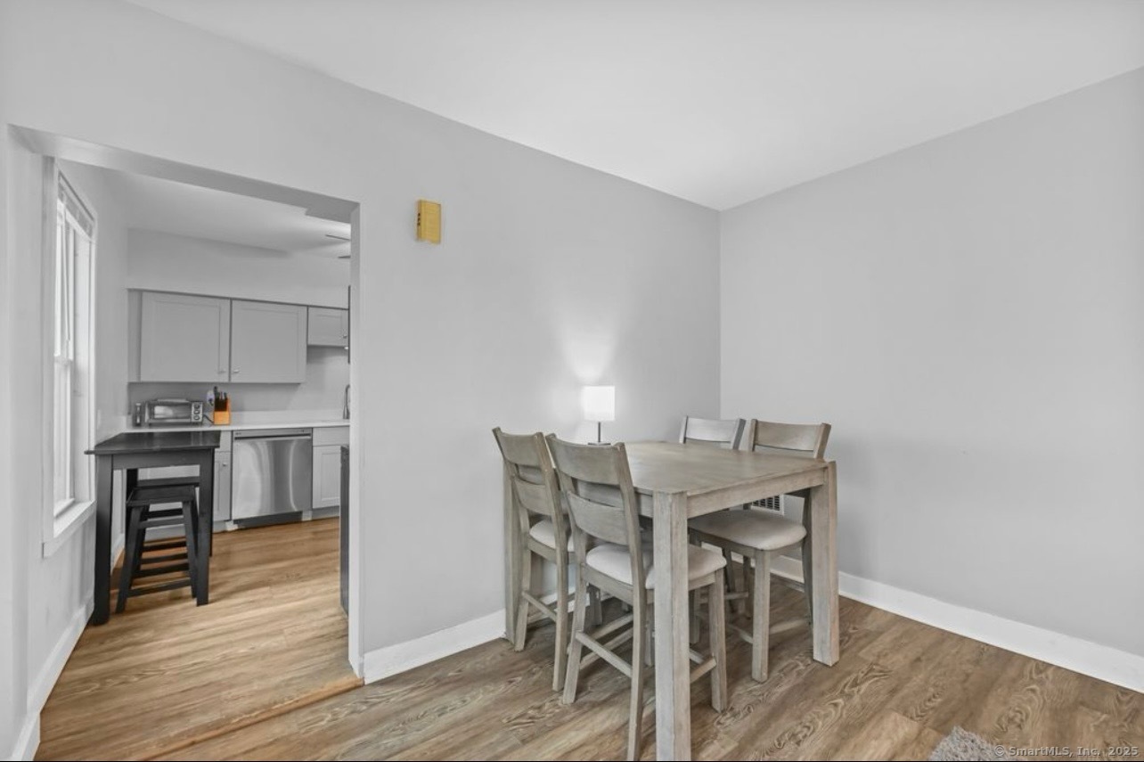 115 Harborview Avenue, Unit 1 Bridgeport, CT 06605 - Photo 3 of 11 a view of a dining room with furniture and wooden floor