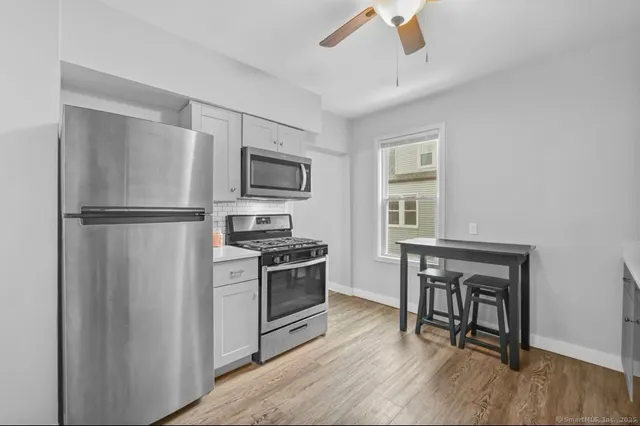 a kitchen with a refrigerator stove top oven and sink