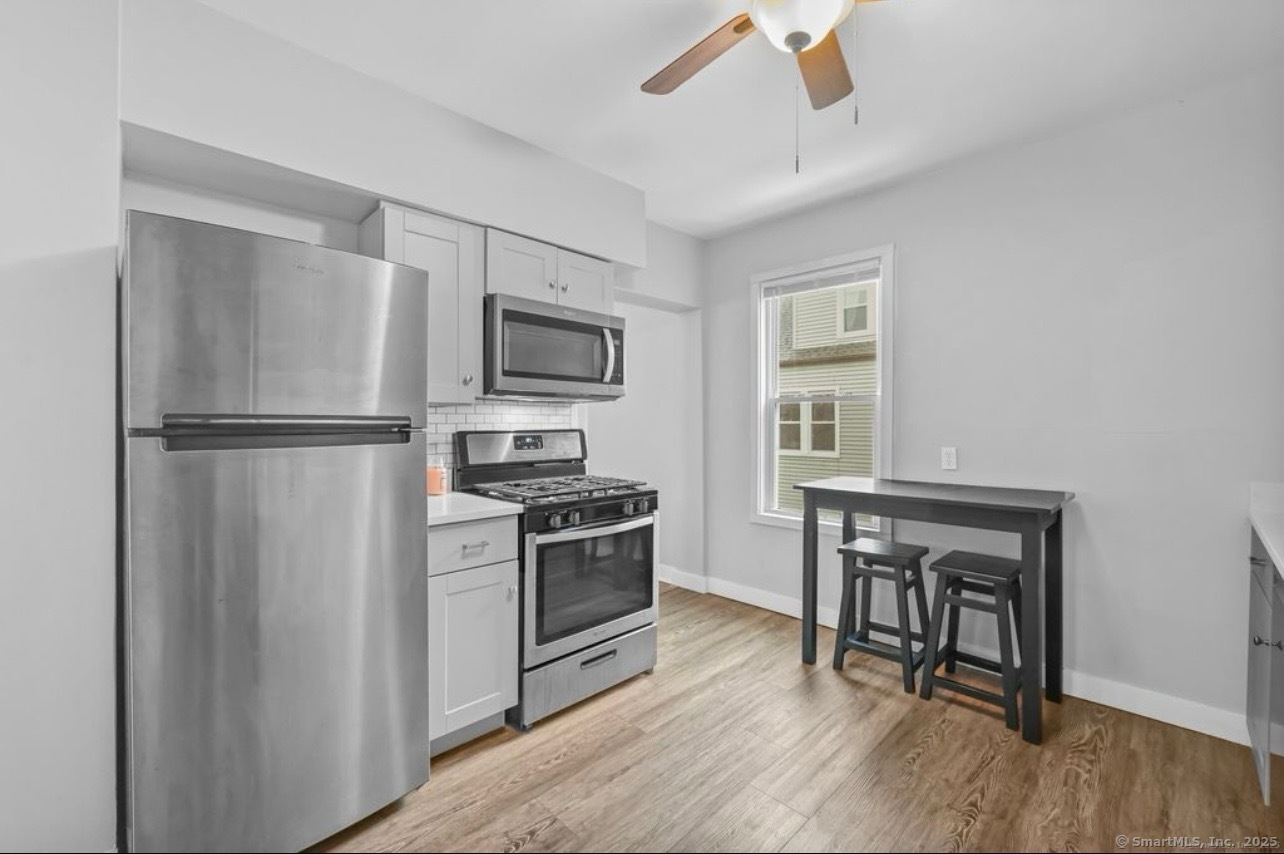 115 Harborview Avenue, Unit 1 Bridgeport, CT 06605 - Photo 4 of 11 a kitchen with a refrigerator stove top oven and sink
