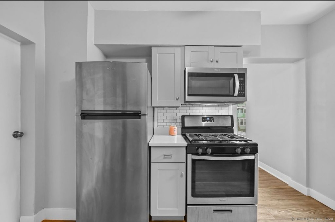 115 Harborview Avenue, Unit 1 Bridgeport, CT 06605 - Photo 5 of 11 a kitchen with a refrigerator stove and microwave