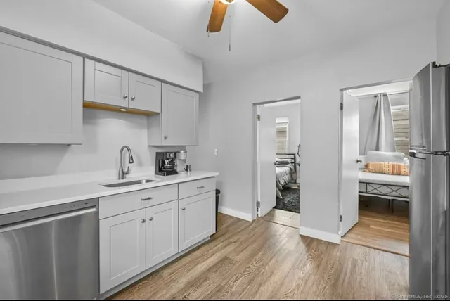 a kitchen with cabinets and wooden floor