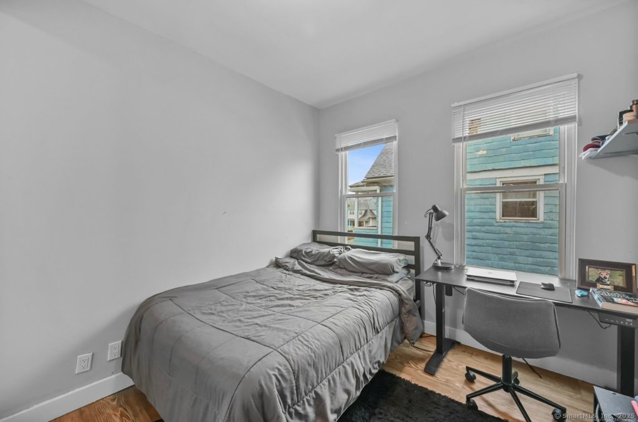 115 Harborview Avenue, Unit 1 Bridgeport, CT 06605 - Photo 9 of 11 a bedroom with a bed and a desk