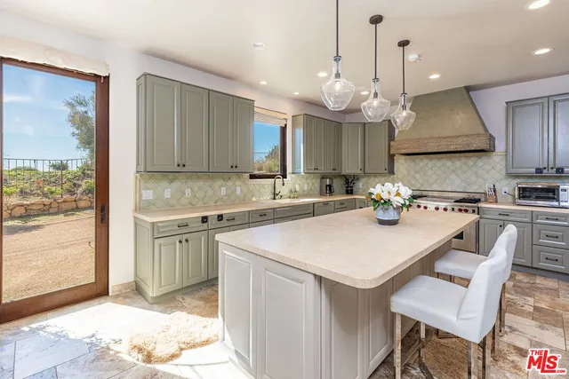 a living room with furniture and a painting