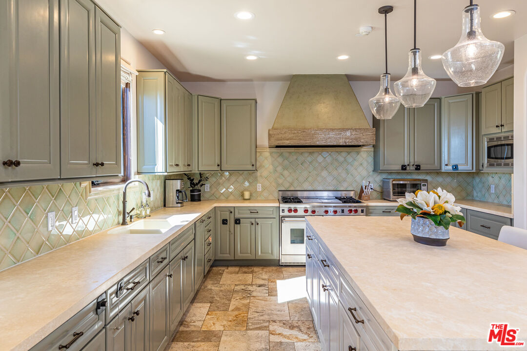 4800 Latigo Canyon Road Malibu, CA 90265 - Photo 17 of 56 a kitchen with a sink a stove and chairs