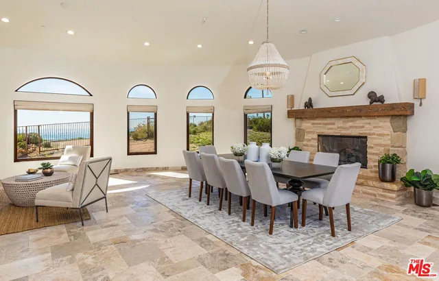a bedroom with a bed a rug and a flat tv screen on the dresser
