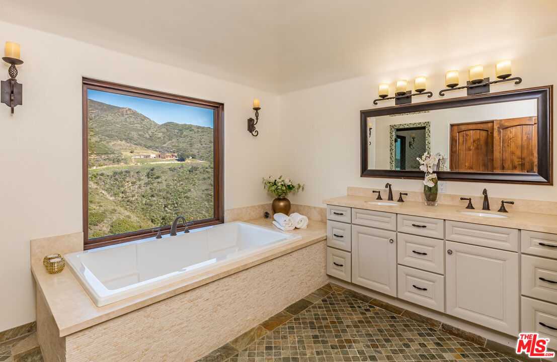 4800 Latigo Canyon Road Malibu, CA 90265 - Photo 30 of 56 a bathroom with a tub sink and mirror