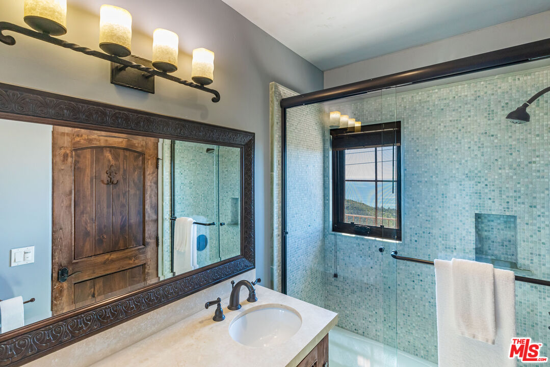 4800 Latigo Canyon Road Malibu, CA 90265 - Photo 35 of 56 a bathroom with a sink and a mirror