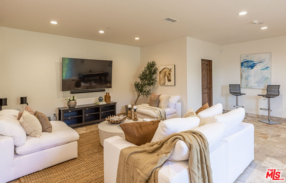 4800 Latigo Canyon Road Malibu, CA 90265 - Photo 40 of 56 a living room with furniture and a flat screen tv