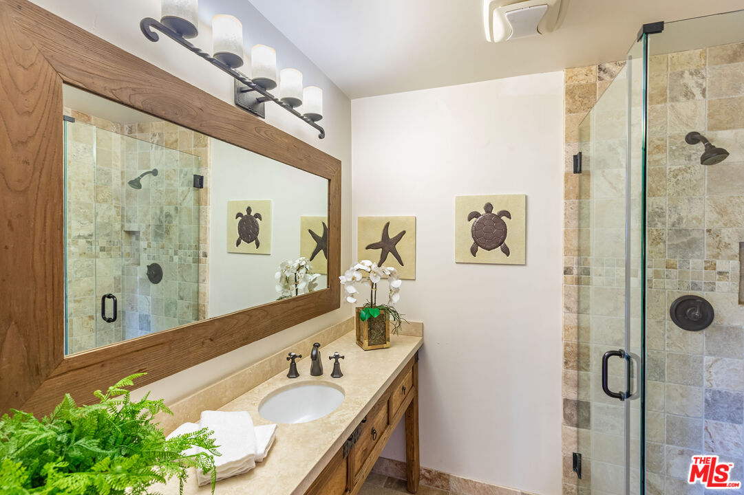 4800 Latigo Canyon Road Malibu, CA 90265 - Photo 42 of 56 a bathroom with a granite countertop double vanity sink mirror and shower
