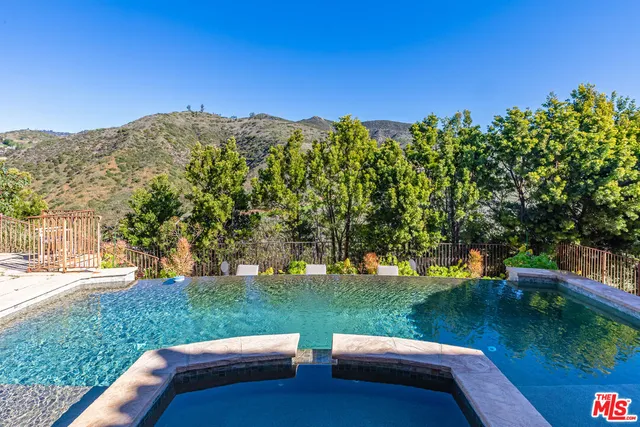 a bathroom with a granite countertop sink mirror vanity and toilet