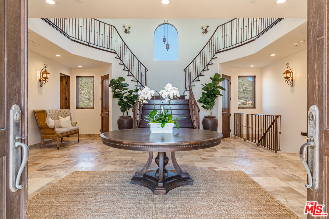 4800 Latigo Canyon Road Malibu, CA 90265 - Photo 9 of 56 a living room with furniture and a chandelier