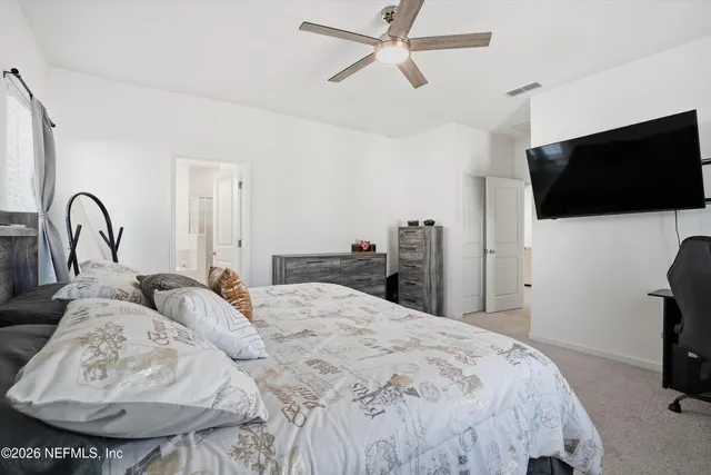 a bedroom with a bed and a flat screen tv