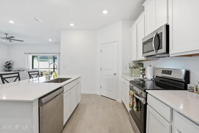 a kitchen with a sink stove and microwave