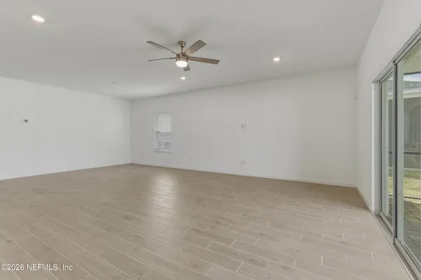 an empty room with a empty space and windows