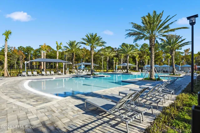 a view of swimming pool with sitting area