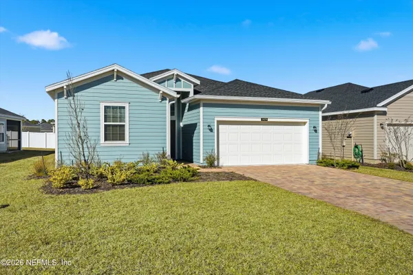 a view of a kitchen with a sink and a refrigerator