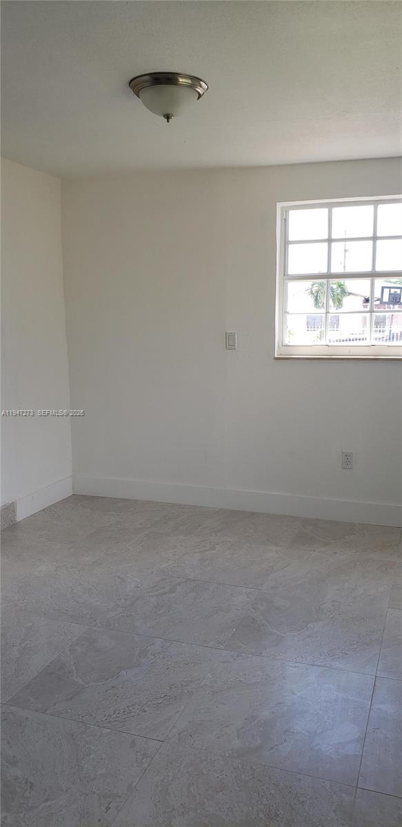 9285 Southwest 37th Street Miami, FL 33165 - Photo 11 of 17 a view of an empty room with a window