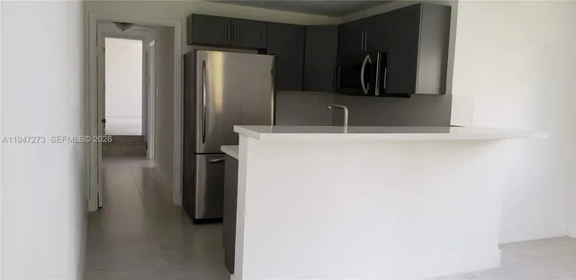 a bathroom with a sink and a refrigerator