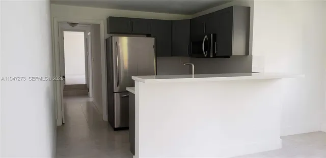 a view of walk in closet with clothes