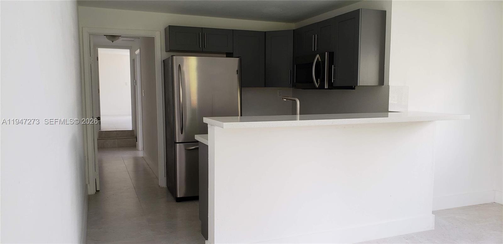 9285 Southwest 37th Street Miami, FL 33165 - Photo 6 of 17 a view of walk in closet with clothes