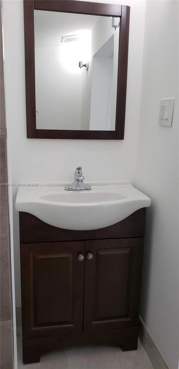 9285 Southwest 37th Street Miami, FL 33165 - Photo 8 of 17 a bathroom with a sink and a mirror